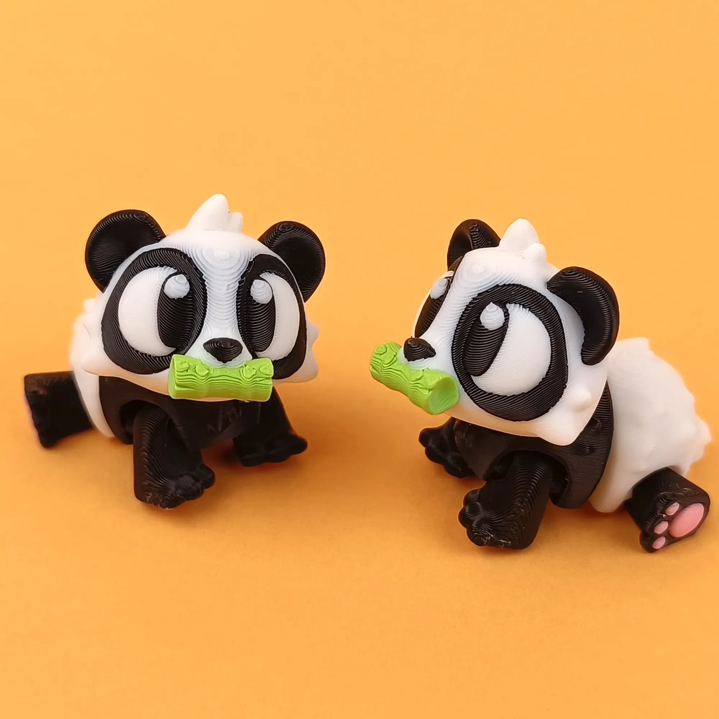 Miniature Flexi Panda by Tattles Told 3D, a detailed 3D-printed panda figurine on a white background.