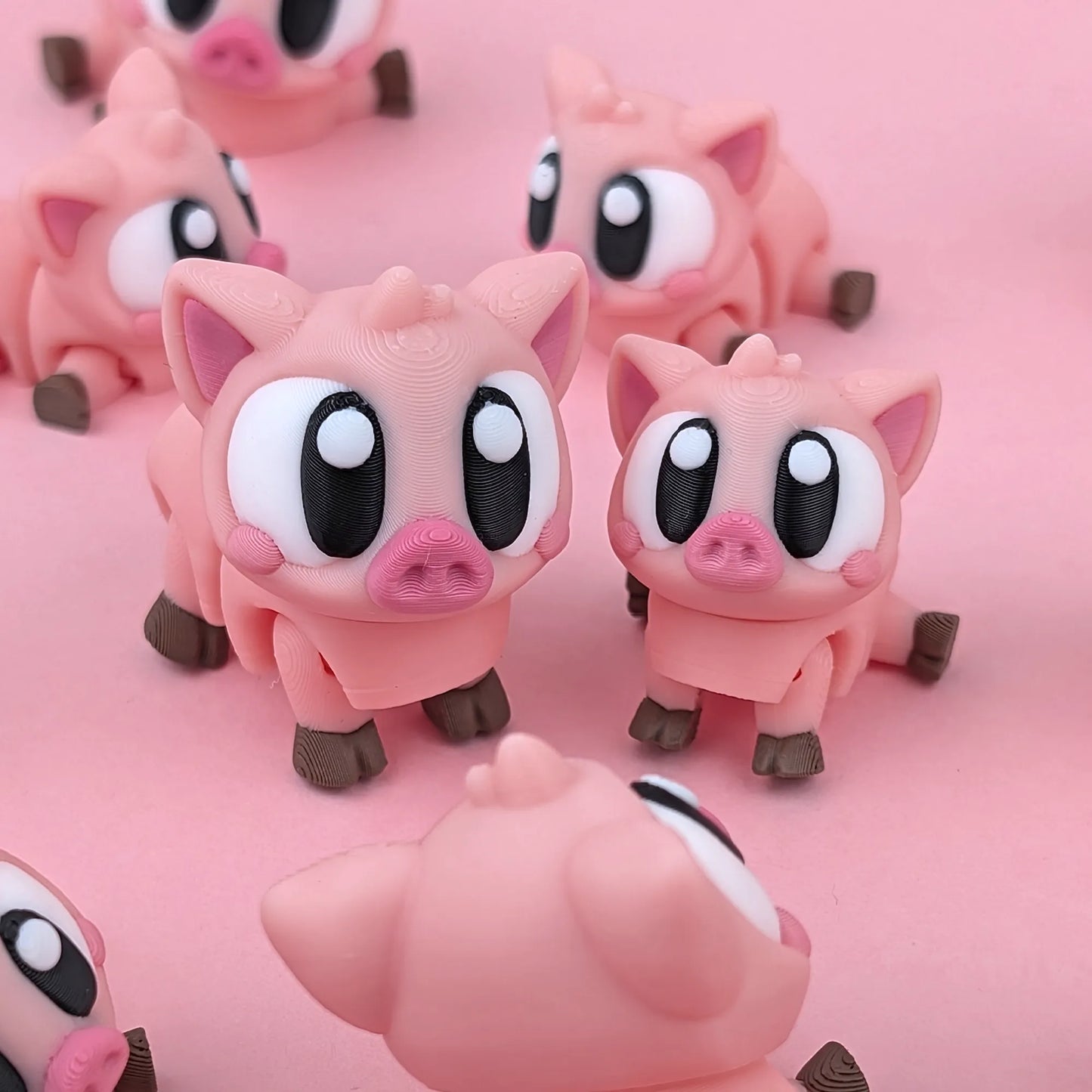 Miniature Flexi Piggy Playset by Tattles Told 3D, featuring colorful piggy figures in a playful design.