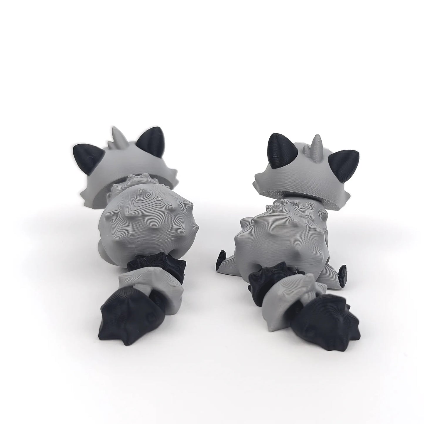 Miniature Flexi Raccoon figurine by Tattles Told 3D, featuring a flexible, detailed raccoon design in a playful pose.