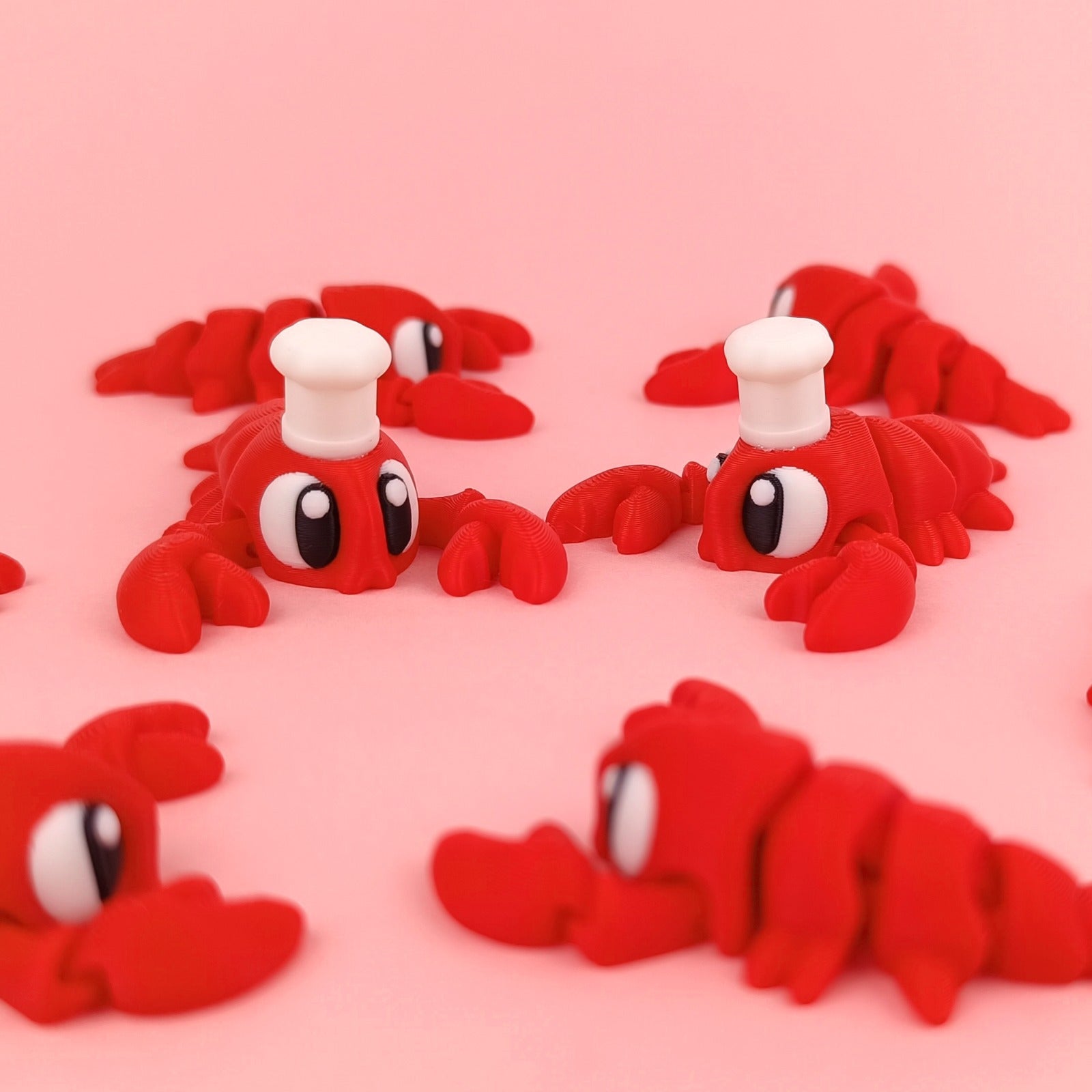 Miniature Flexi Lobster figurine by Tattles Told 3D, featuring detailed sculpting and vibrant red color on a plain background.