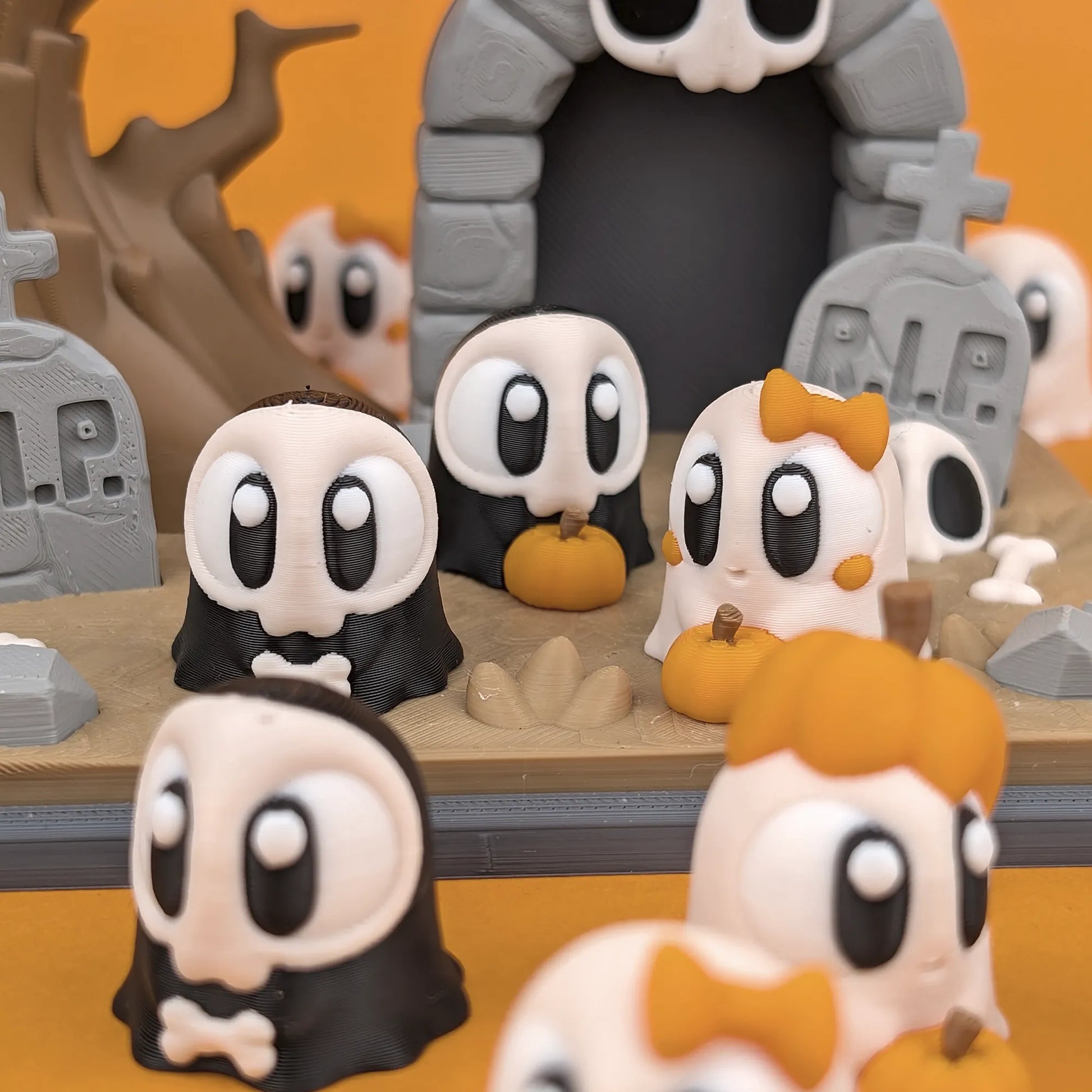 Miniature ghost figures and graveyard scene from Tattles Told 3D Mini Ghost & Graveyard Playset, detailed spooky Halloween decor.