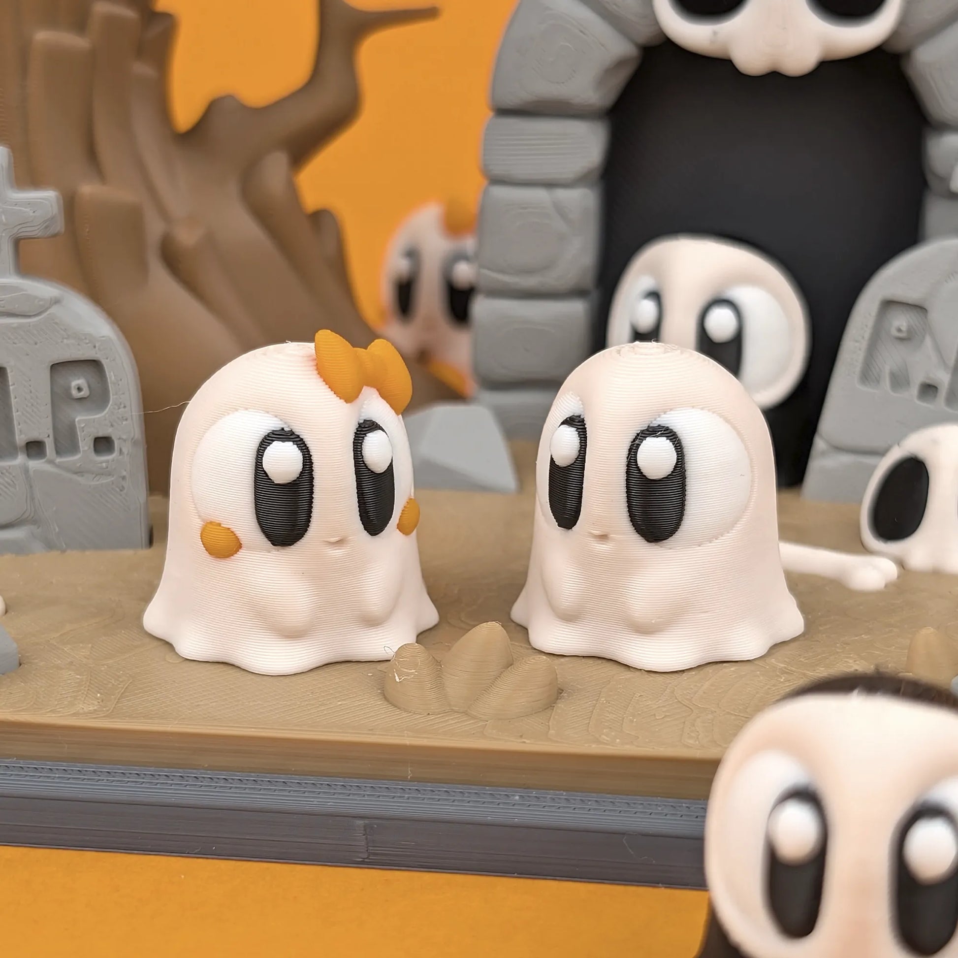 Miniature ghost figures and gravestone playset from Tattles Told 3D's Mini Ghost & Graveyard Playset, featuring spooky themed accessories.