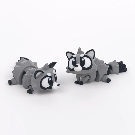 Miniature Flexi Raccoon figure by Tattles Told 3D, featuring detailed design and flexible body for playful display.