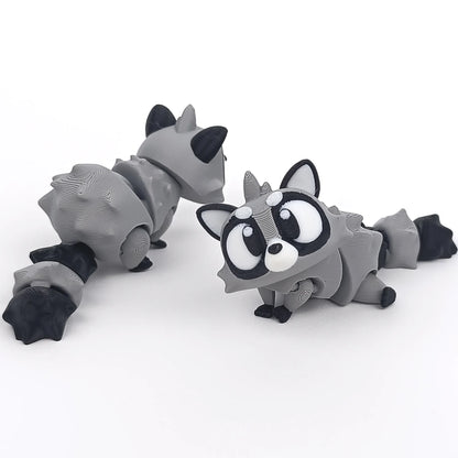Miniature Flexi Raccoon figure by Tattles Told 3D, colorful and detailed 3D-printed raccoon sculpture.