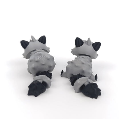 Miniature Flexi Raccoon figurine by Tattles Told 3D, featuring a flexible, detailed raccoon design in a playful pose.