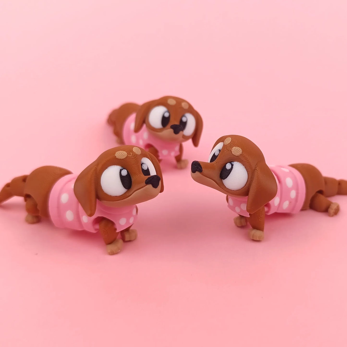 Miniature Flexi Sausage Dog toy by Tattles Told 3D, flexible silicone figure with detailed features on a plain background.
