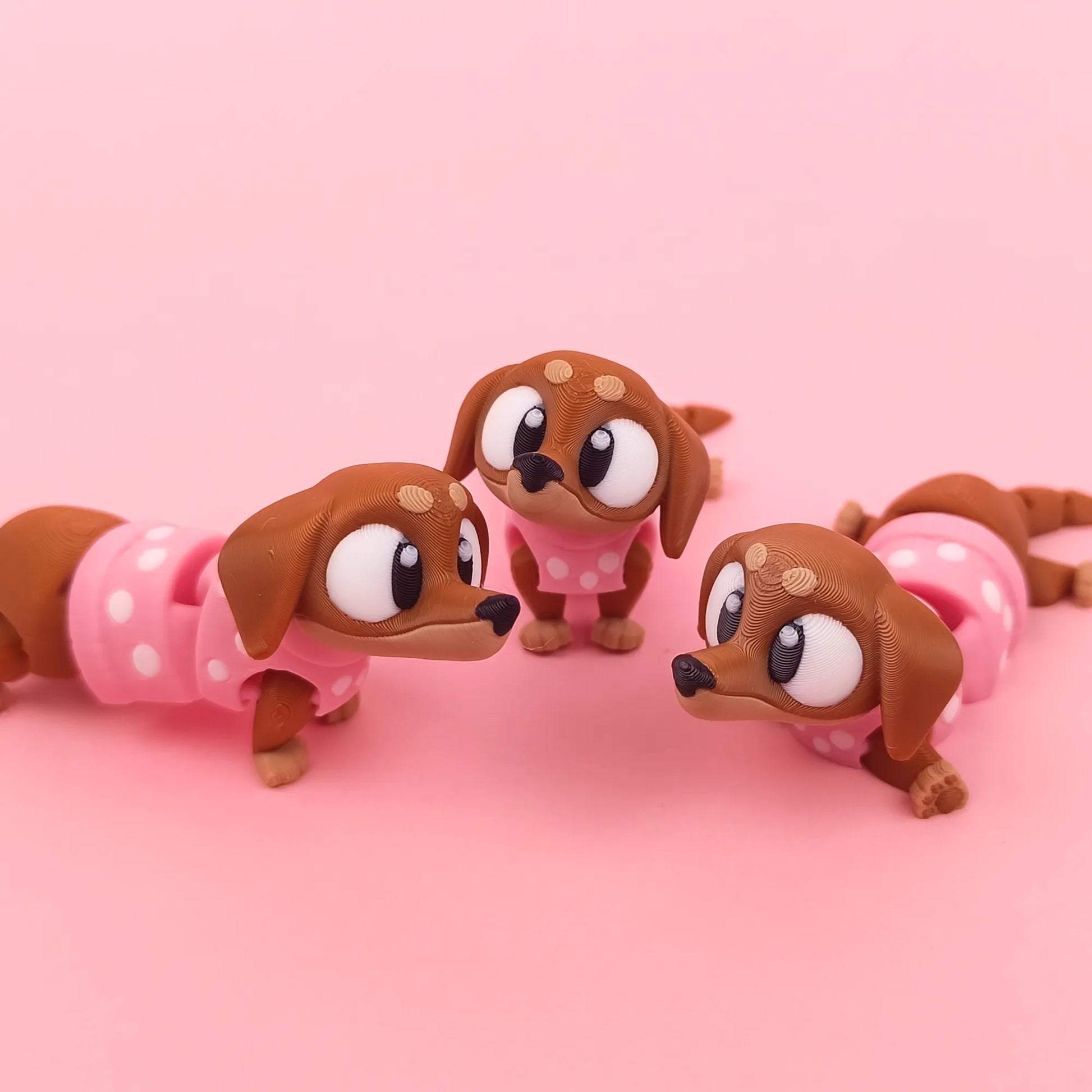 Miniature Flexi Sausage Dog toy by Tattles Told 3D, flexible and detailed plush dog figure in playful pose.