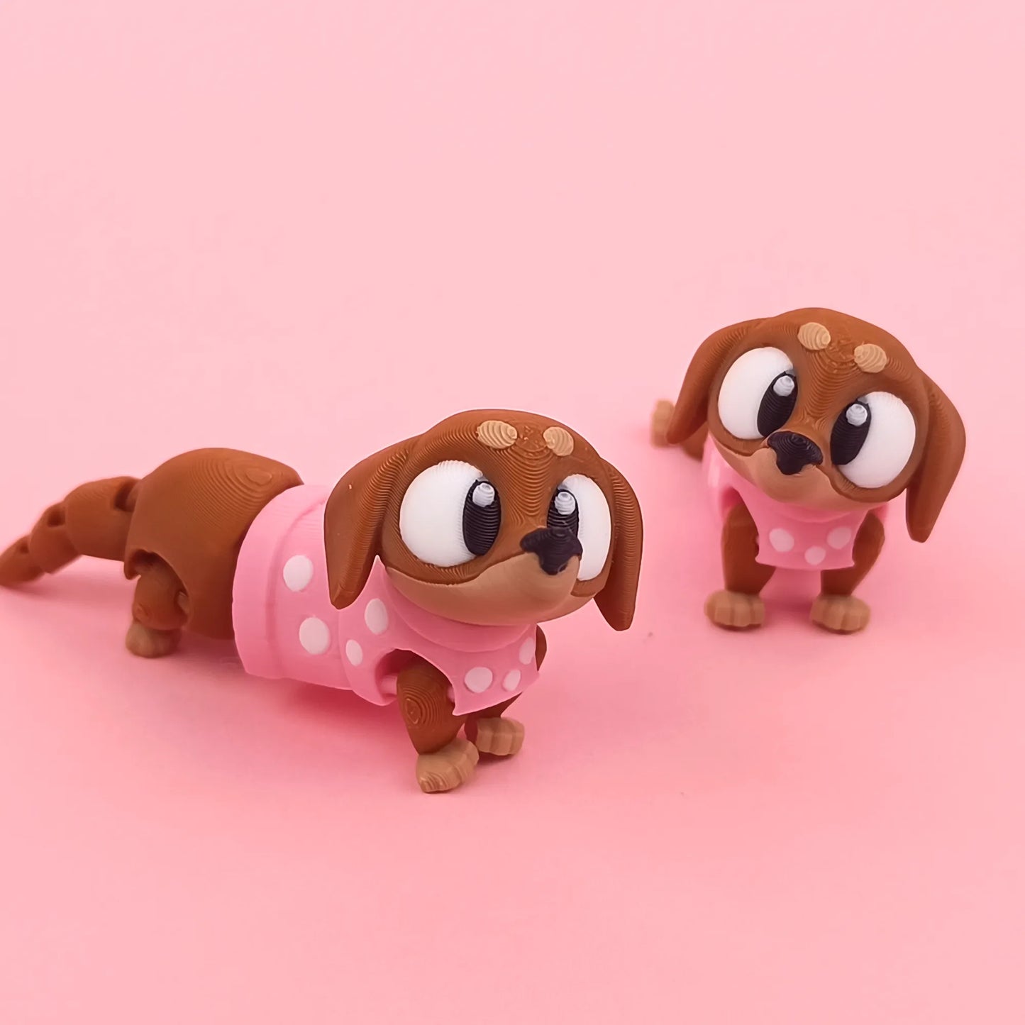 Miniature Flexi Sausage Dog figurine by Tattles Told 3D, featuring a flexible, detailed sausage dog design in a compact form.