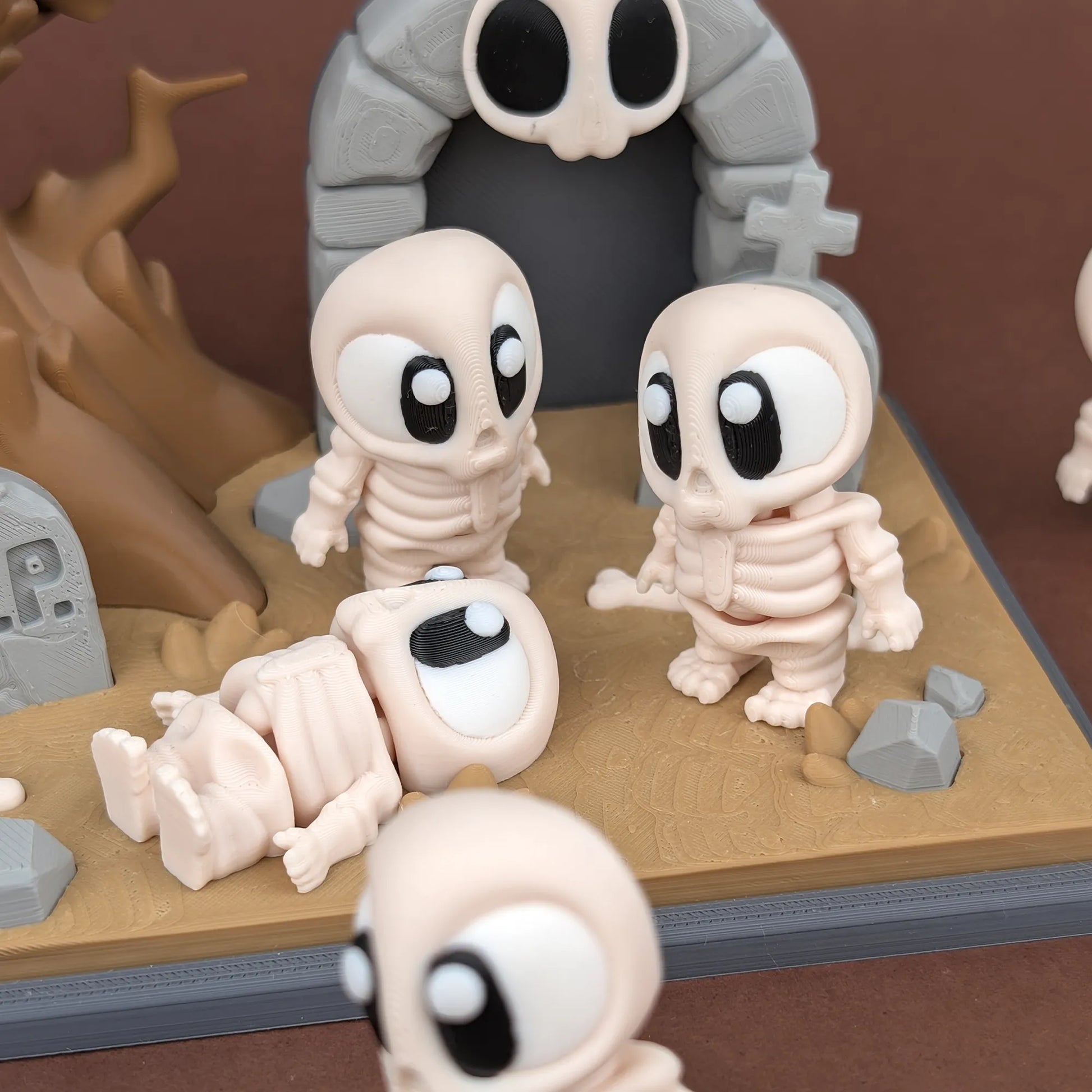 Mini skeleton figure from Tattles Told 3D's Miniature Skeleton & Graveyard Playset, shown on a dark background.