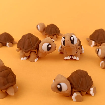 Miniature Flexi Tortoise figurine by Tattles Told 3D, featuring a detailed tortoise design with a flexible body and tortoise shell pattern.